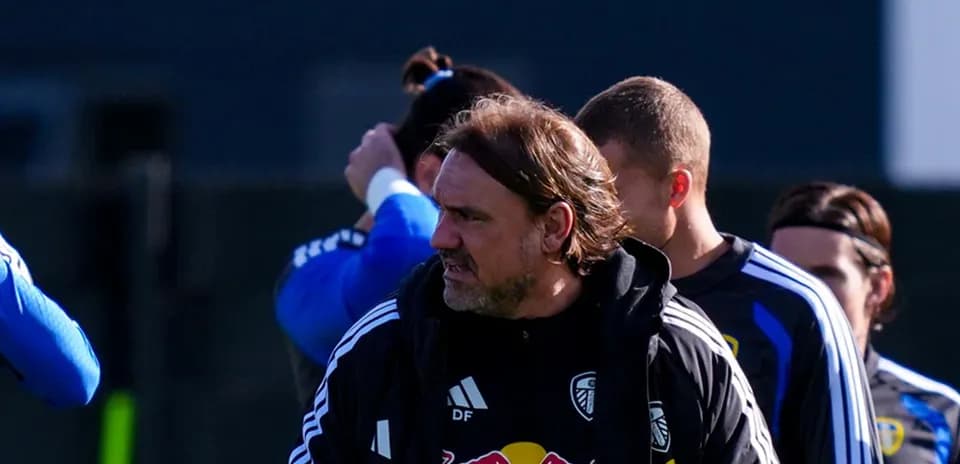 Coach observing players during training session