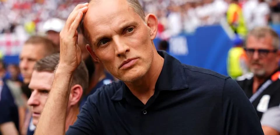 Coach observing match with focused expression