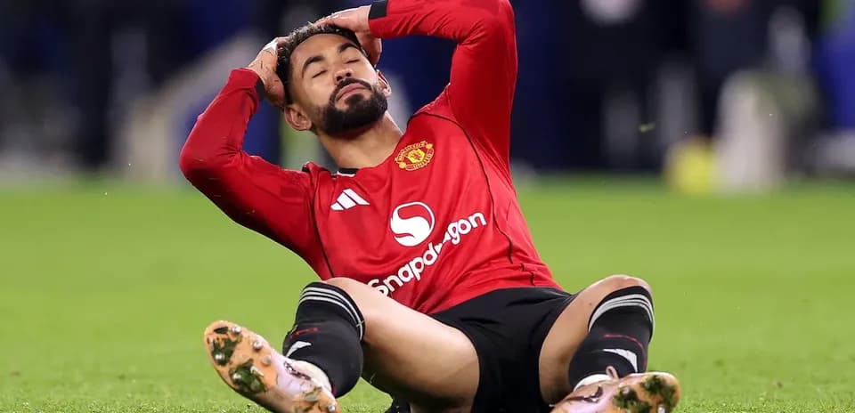 Player sitting on field, holding head in frustration