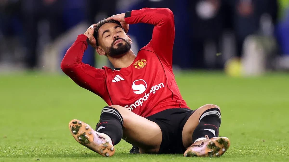 Player sitting on field, holding head in frustration