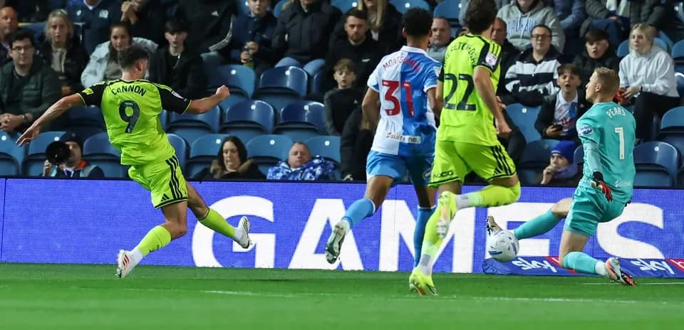 Player shooting at goal during a football match