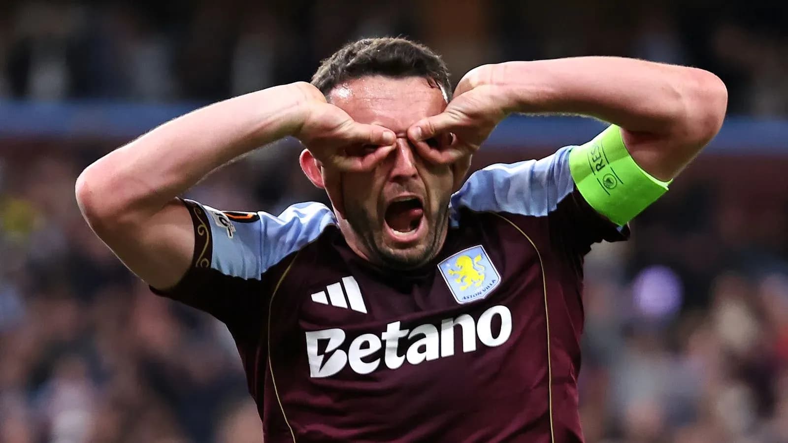 Player celebrating with hands on face in stadium
