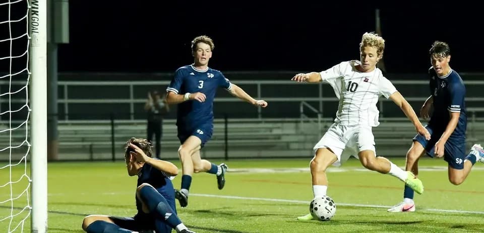 Player attempting to score as goalie defends