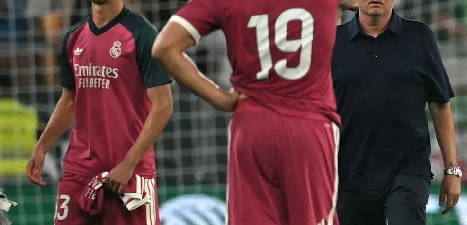 Players and coach discussing after match conclusion