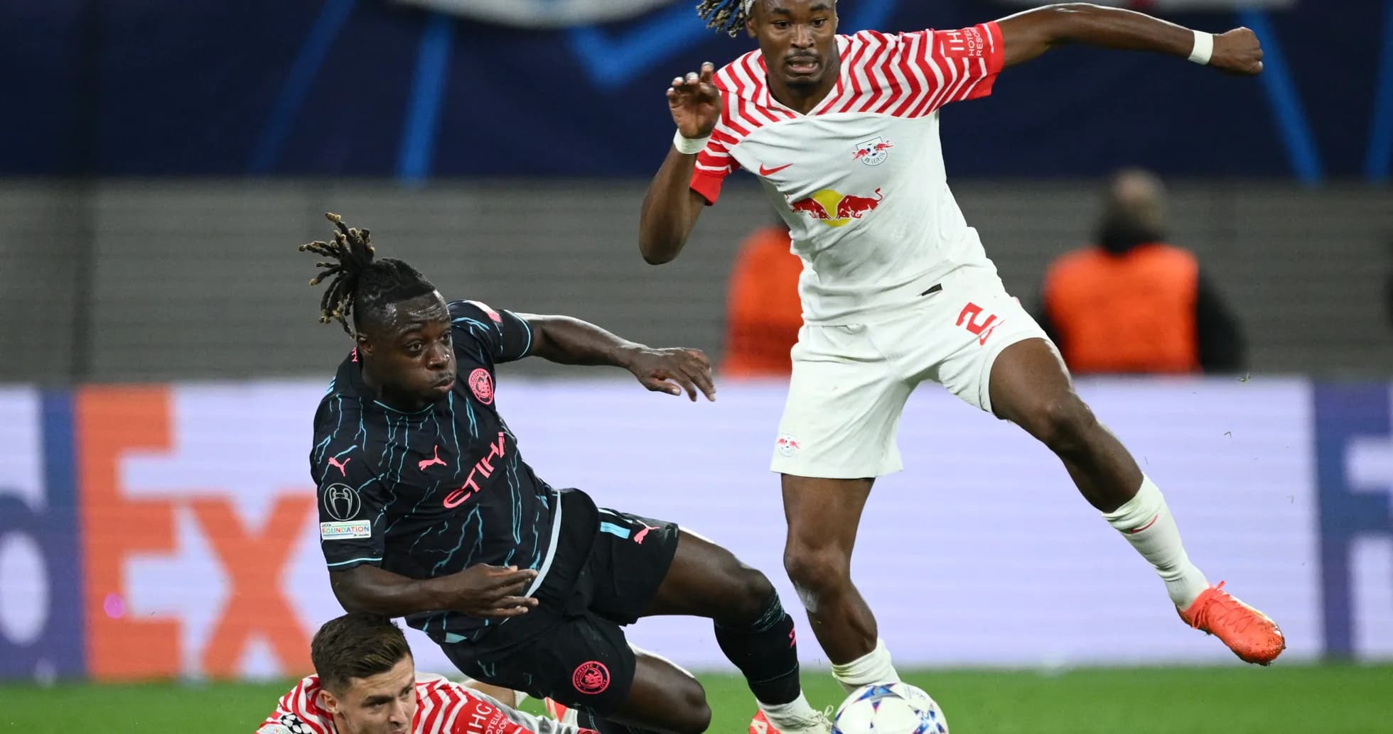 RB Leipzig player challenging Manchester City opponent