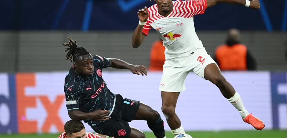 RB Leipzig player challenging Manchester City opponent