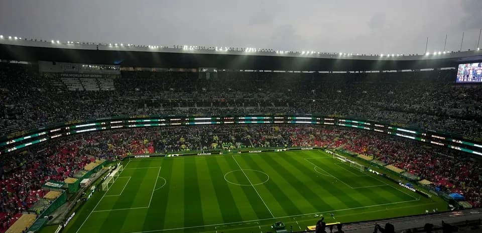 Full stadium with green soccer field before match