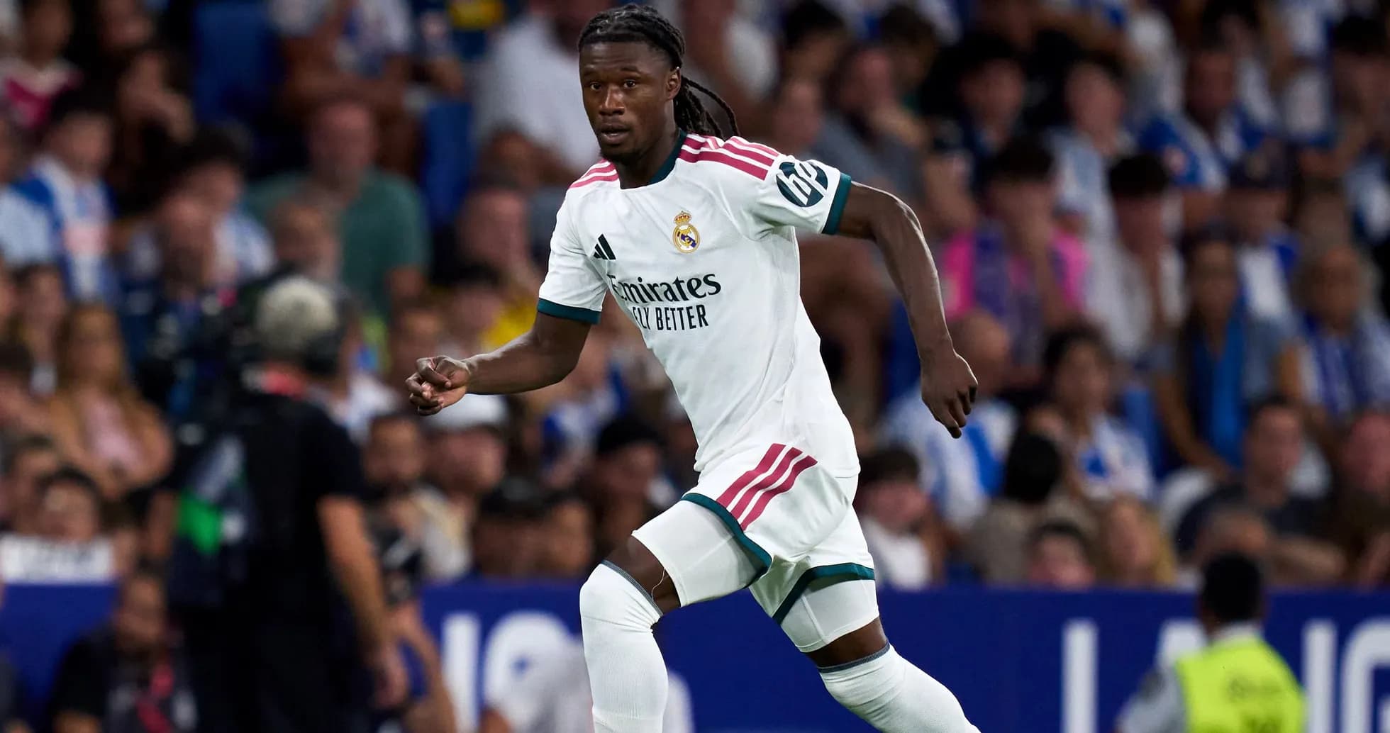Player running during a match in white jersey