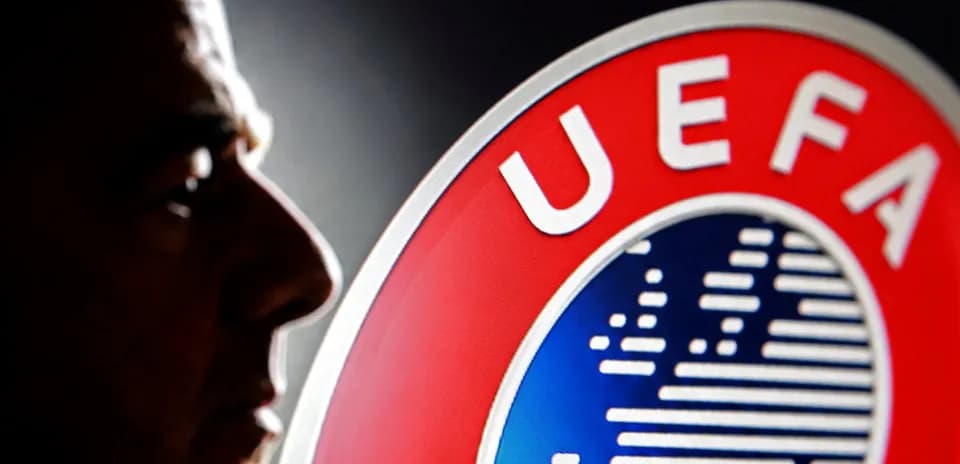 Silhouette of a man beside UEFA logo