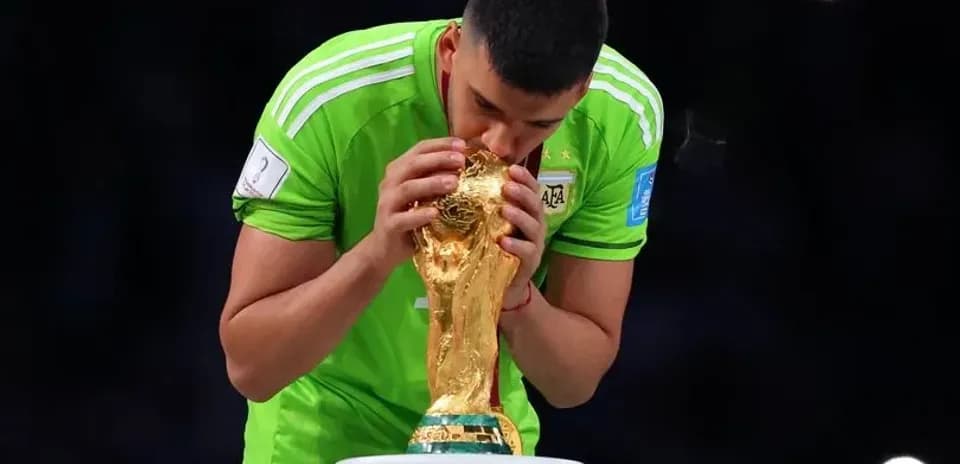 Goalkeeper kissing the FIFA World Cup trophy