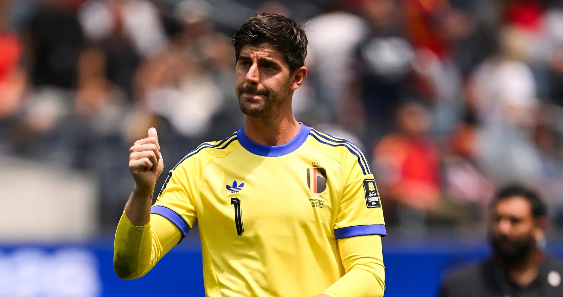 Goalkeeper in yellow jersey gesturing on the field