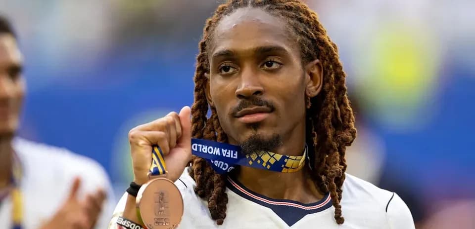 Player holding FIFA World Cup bronze medal