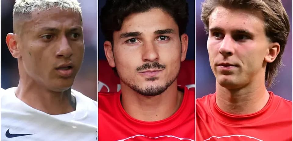 Three soccer players posing for camera