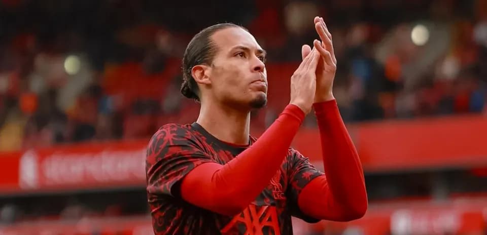 Player applauding fans at Anfield stadium
