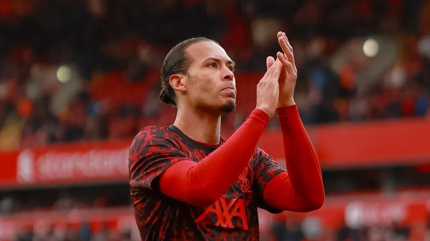Player applauding fans at Anfield stadium