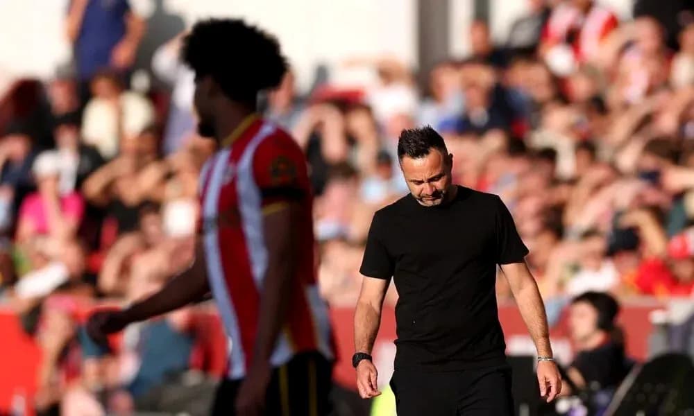 Manager walking past player during match at stadium