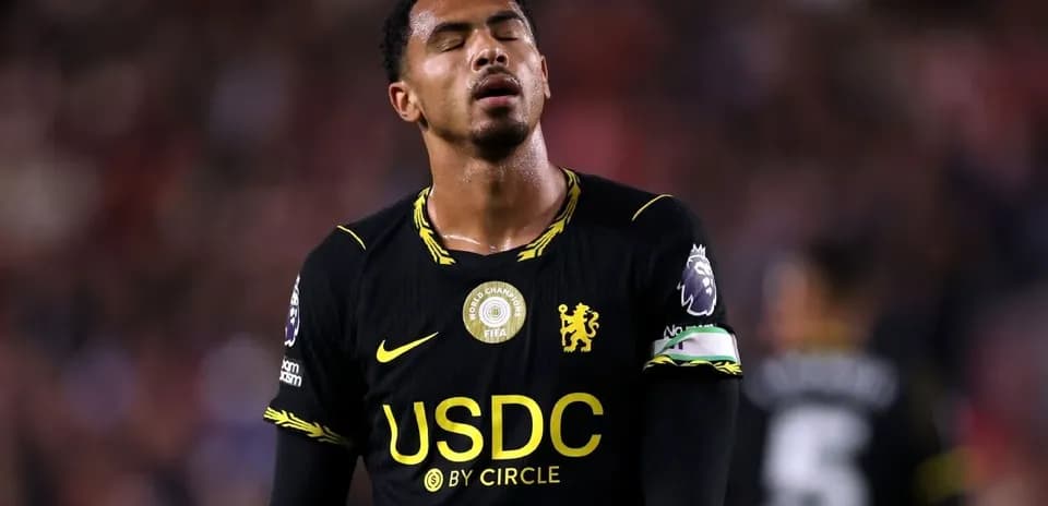 Player in black jersey looking down on field