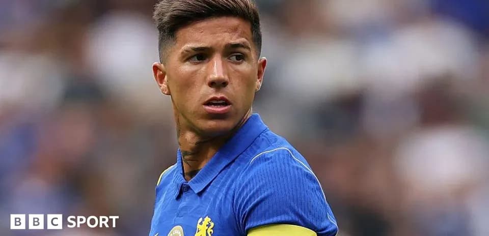 Player wearing blue jersey with 'CAPTAIN' armband