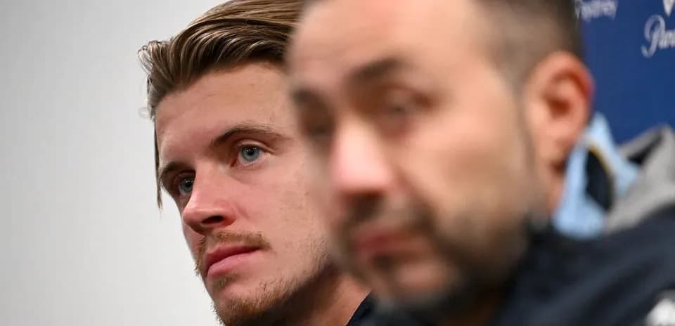 Two individuals at a press conference backdrop