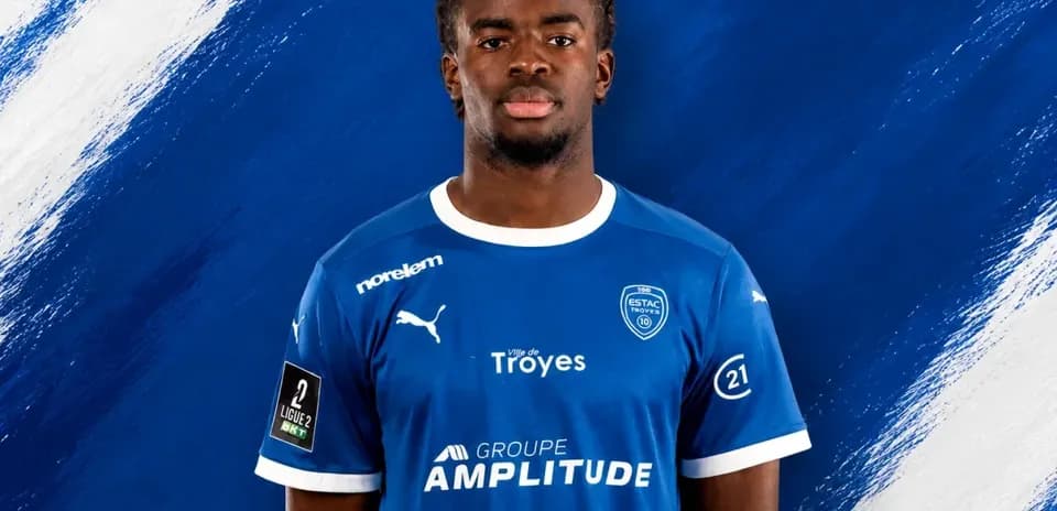 Player in blue jersey with sponsor logos