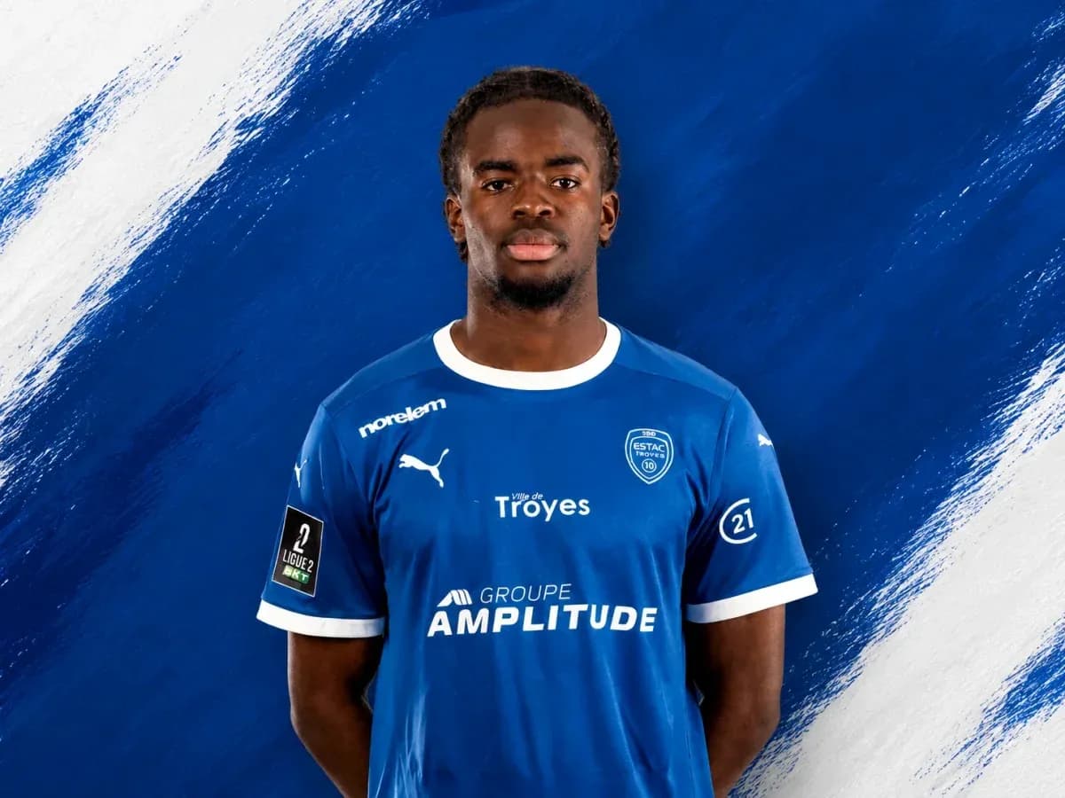 Player in blue jersey with sponsor logos