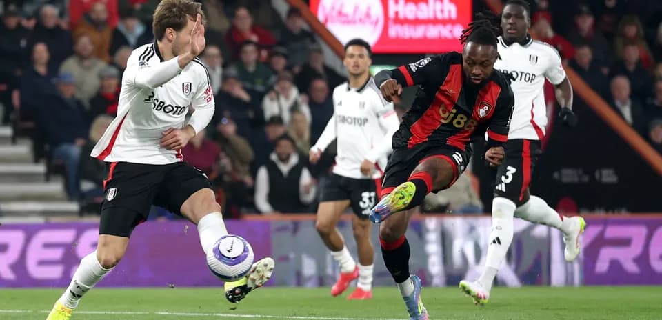 Fulham player challenges Bournemouth player during match