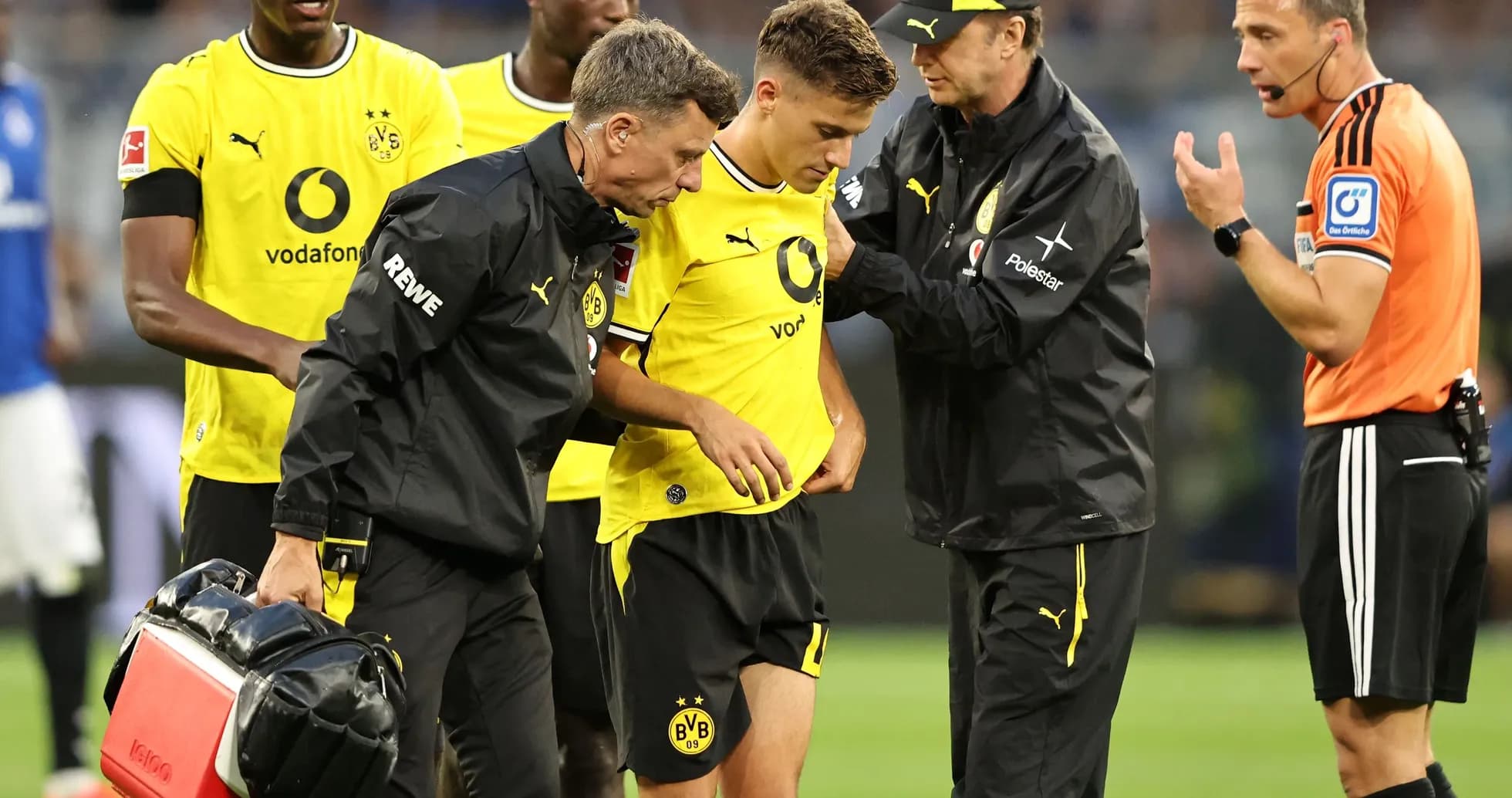 Medical staff attending to injured Borussia Dortmund player
