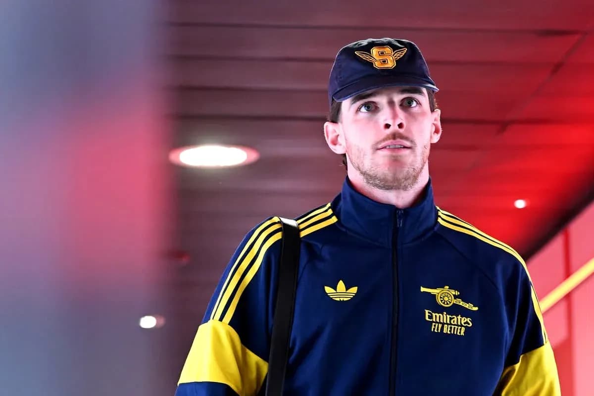 Player walking in team tracksuit with bag