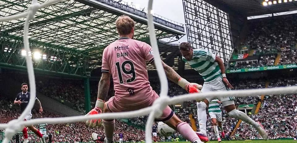 Goalkeeper attempting to save shot during match