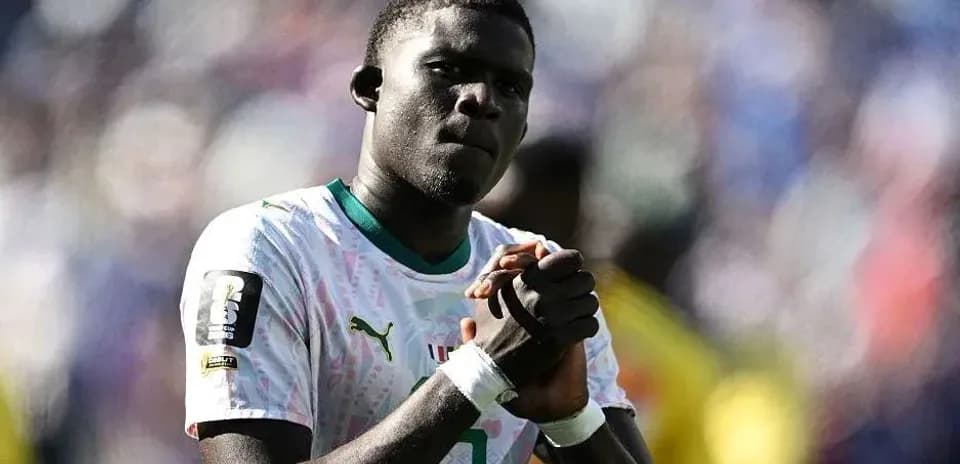 Player clasping hands during match celebration