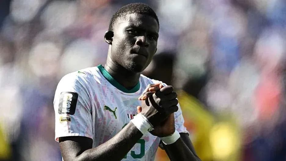 Player clasping hands during match celebration