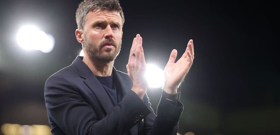 Coach applauding in stadium with bright lights