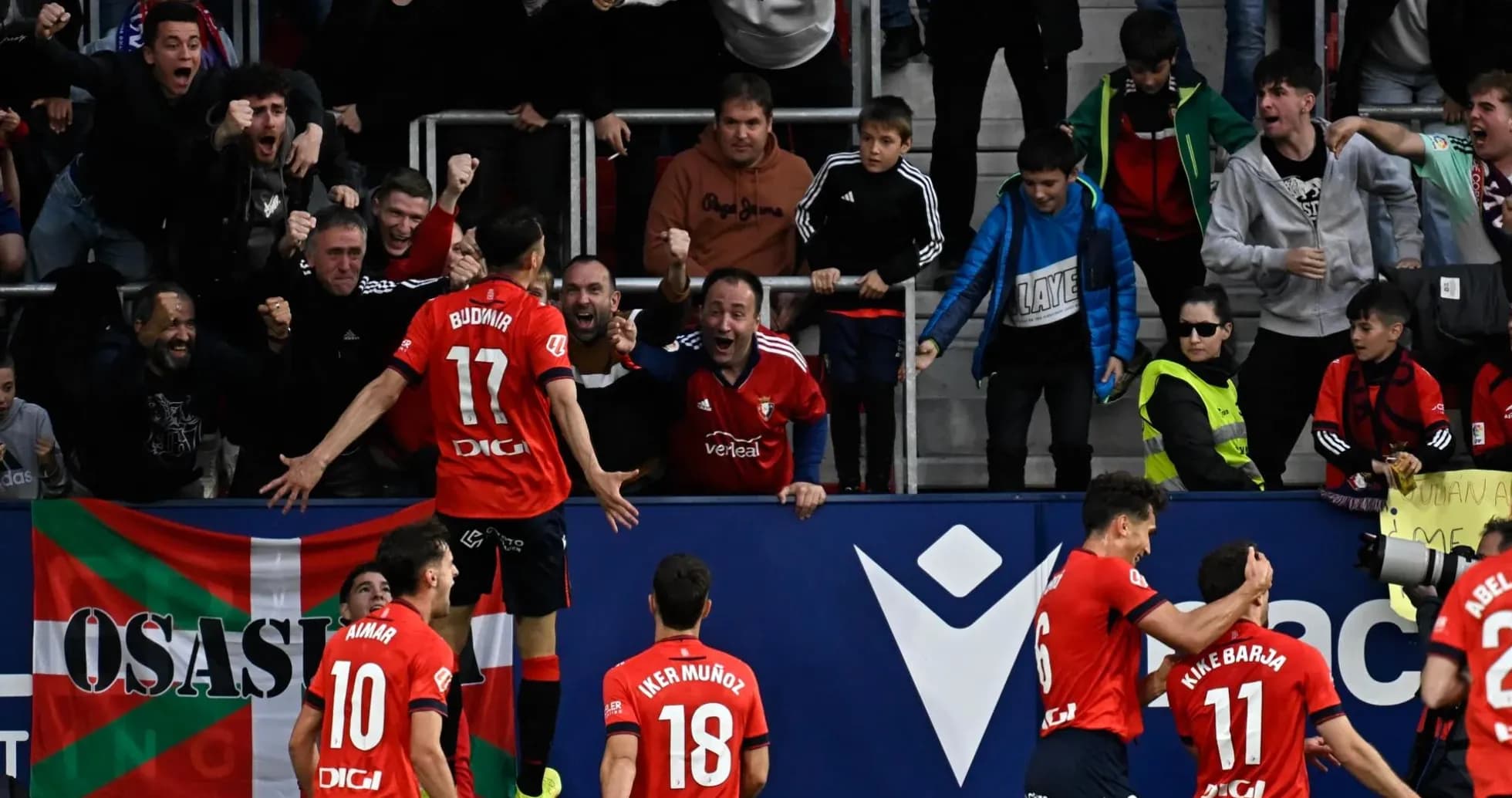 Osasuna players celebrating a goal with fans