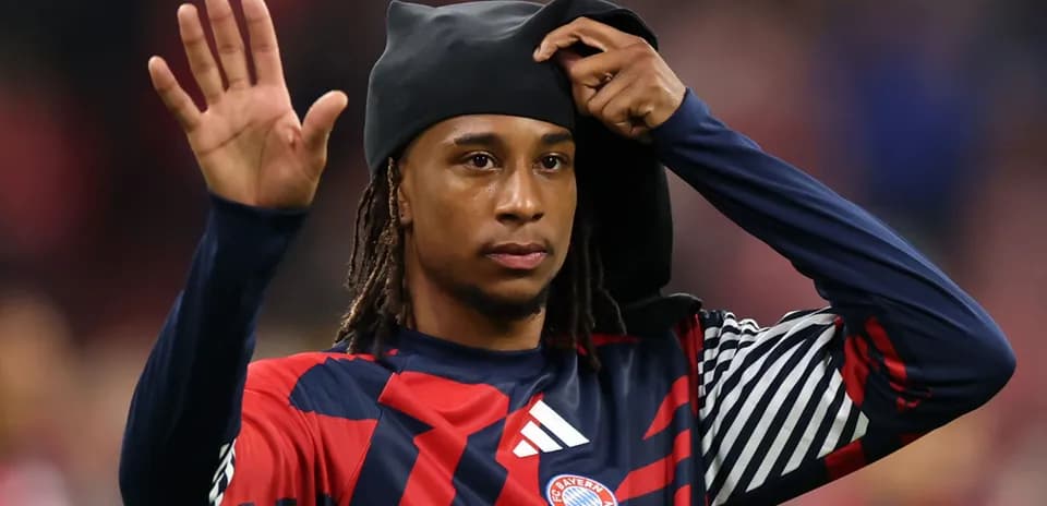 Player waving while adjusting his headwear
