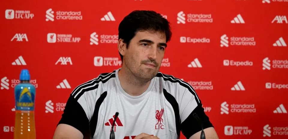 Manager seated at press conference table with branding