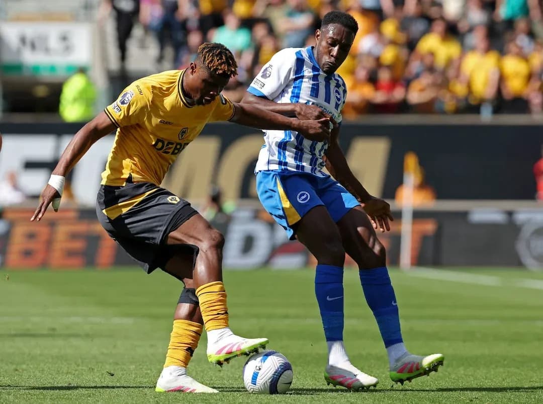 Brighton player challenging Wolves opponent for the ball