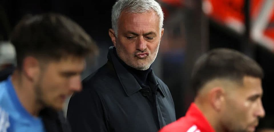 Manager observing players on the sidelines during match