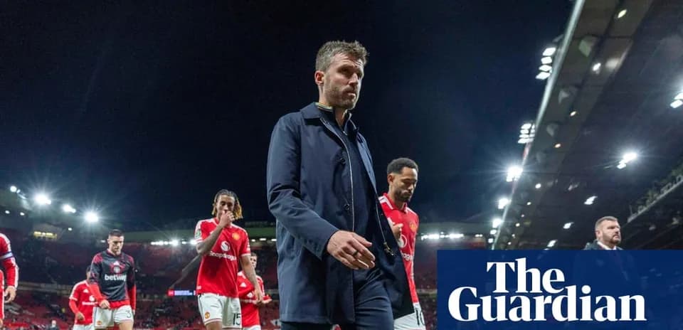 Manager walking off pitch with players after match
