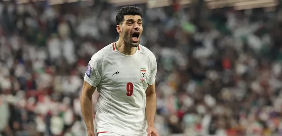 Iran player celebrating during World Cup match