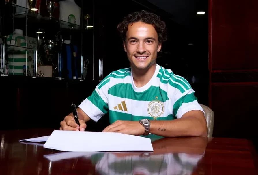 Player signing contract while wearing team jersey