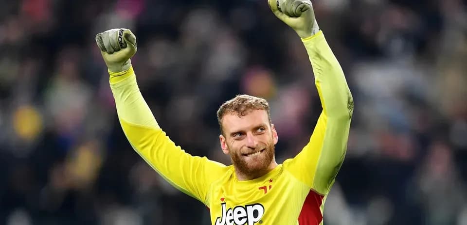 Goalkeeper celebrating with raised arms after match
