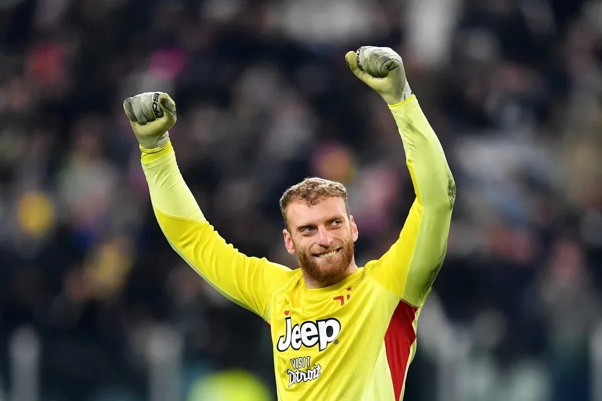 Goalkeeper celebrating with raised arms after match