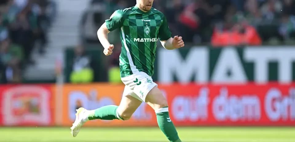 Player running with ball during match at stadium
