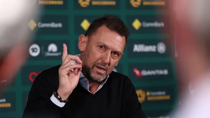 Manager speaking at press conference with hand raised