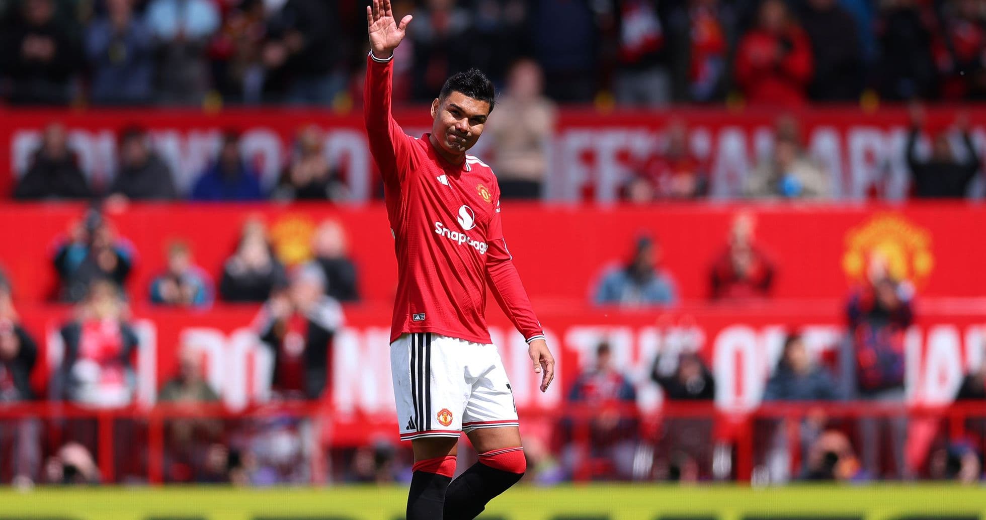Player waving to fans at stadium during match