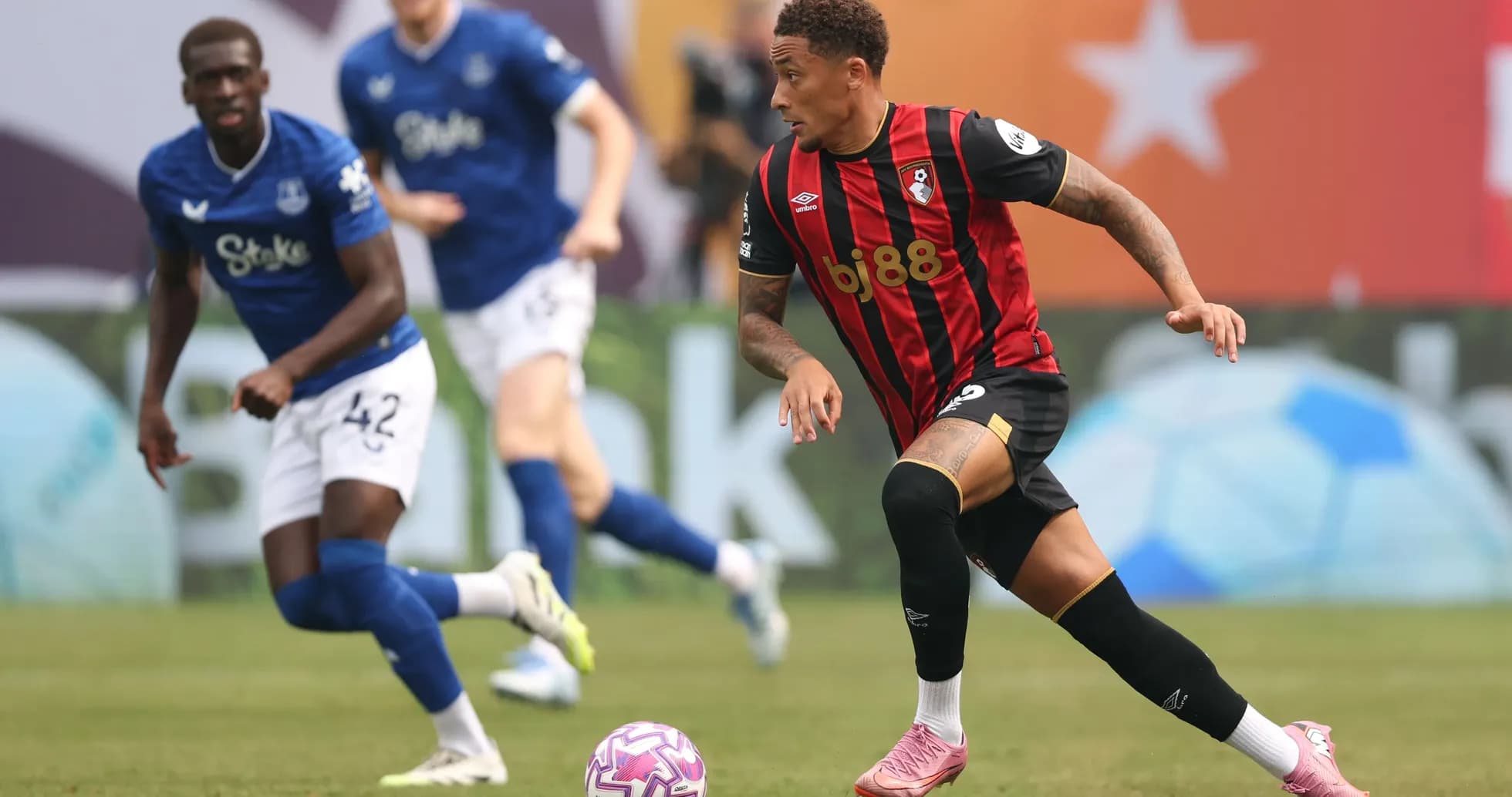 Bournemouth player dribbling past Everton defender