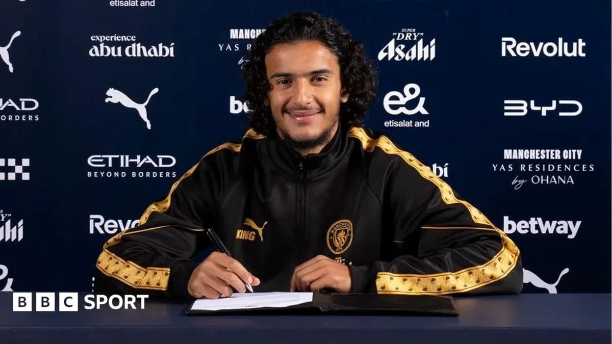 Player signing contract at Manchester City press event