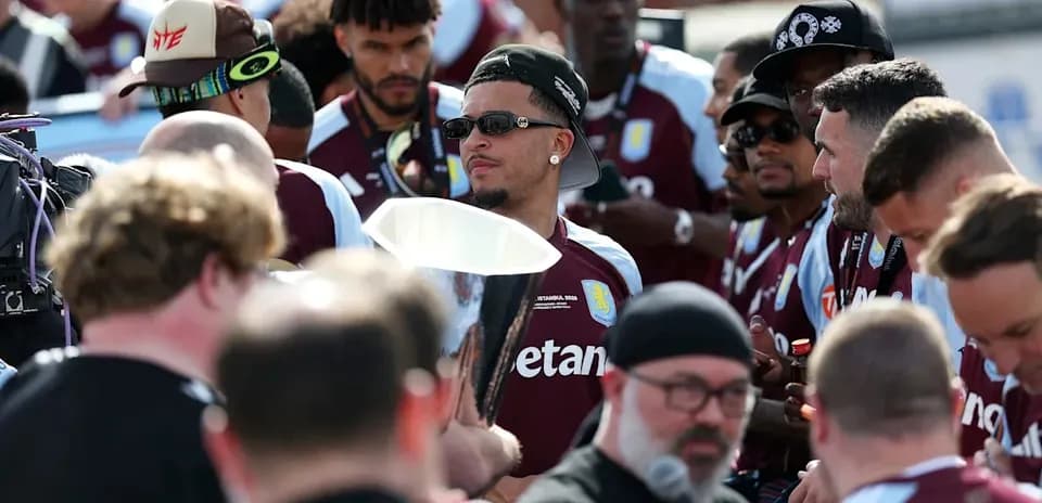 Aston Villa players gathered with a trophy