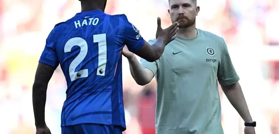 Player Hato shaking hands with Chelsea staff