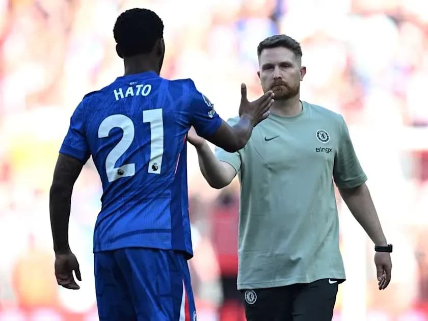 Player Hato shaking hands with Chelsea staff